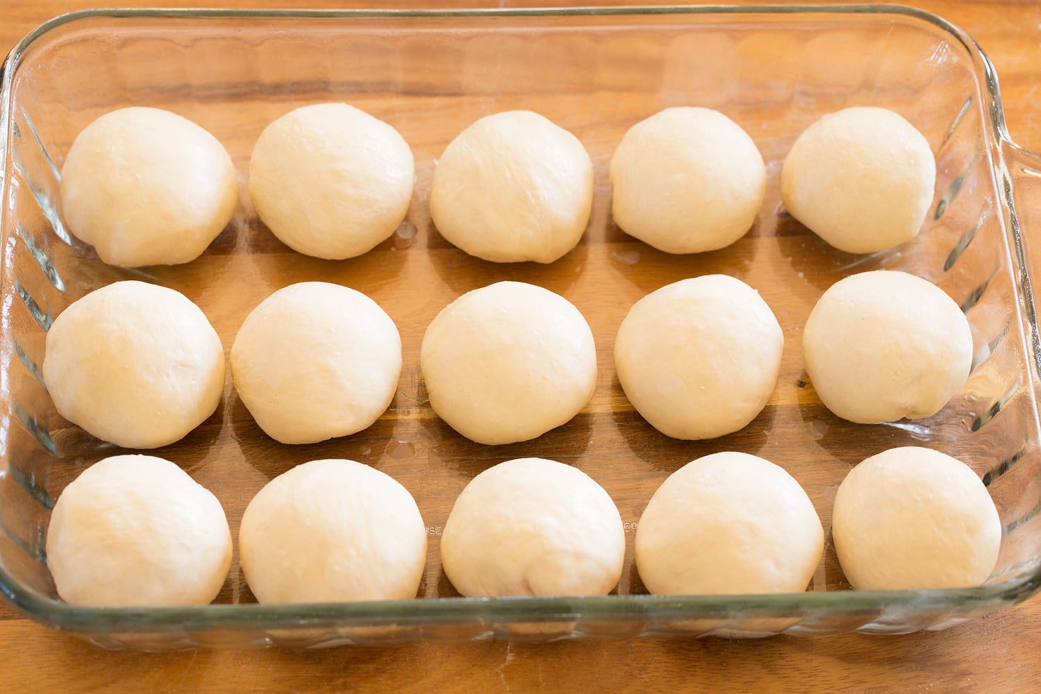 One Hour Dinner Rolls Rolls in baking dish before rising.