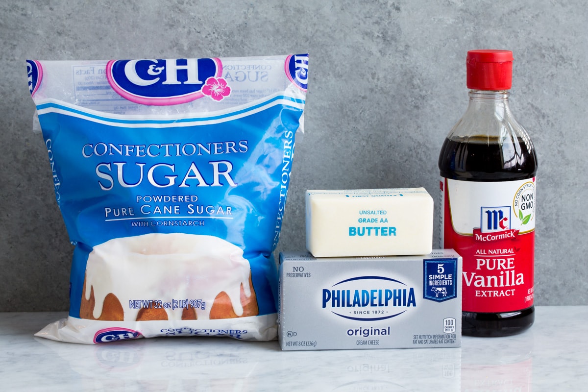 Cream Cheese Frosting Ingredients used to make cream cheese frosting shown here including powdered sugar, cream cheese, butter and vanilla extract.