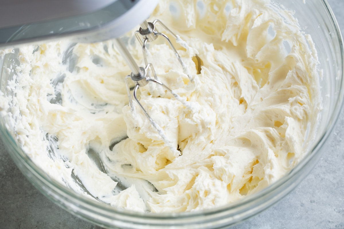 Cream Cheese Frosting Cream cheese and butter shown after blending with beaters resting in mixture.