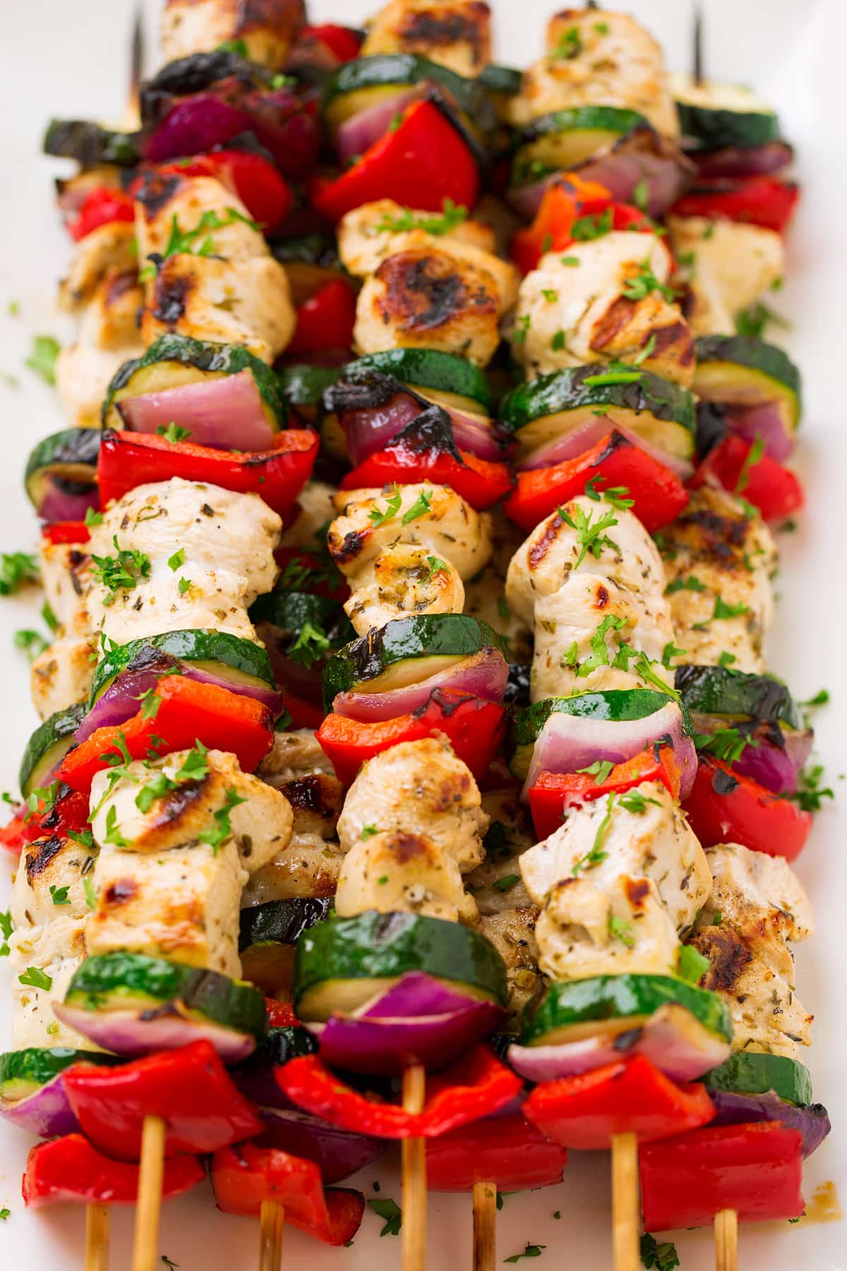 Greek Chicken Kebabs Greek Chicken Kebabs on skewers with marinated chicken breast, zucchini, bell pepper and red onion.
