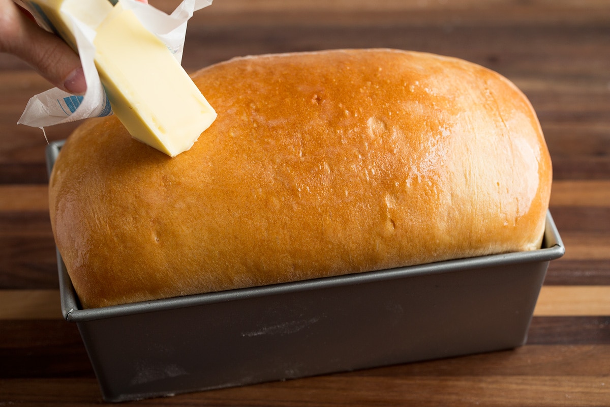 Homemade Bread Running a stick of butter over a loaf of bread.