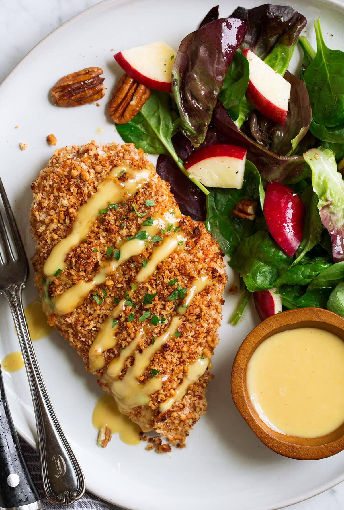 Honey Mustard Pecan Crusted Chicken Pecan chicken with honey mustard glaze with a side salad on the side.
