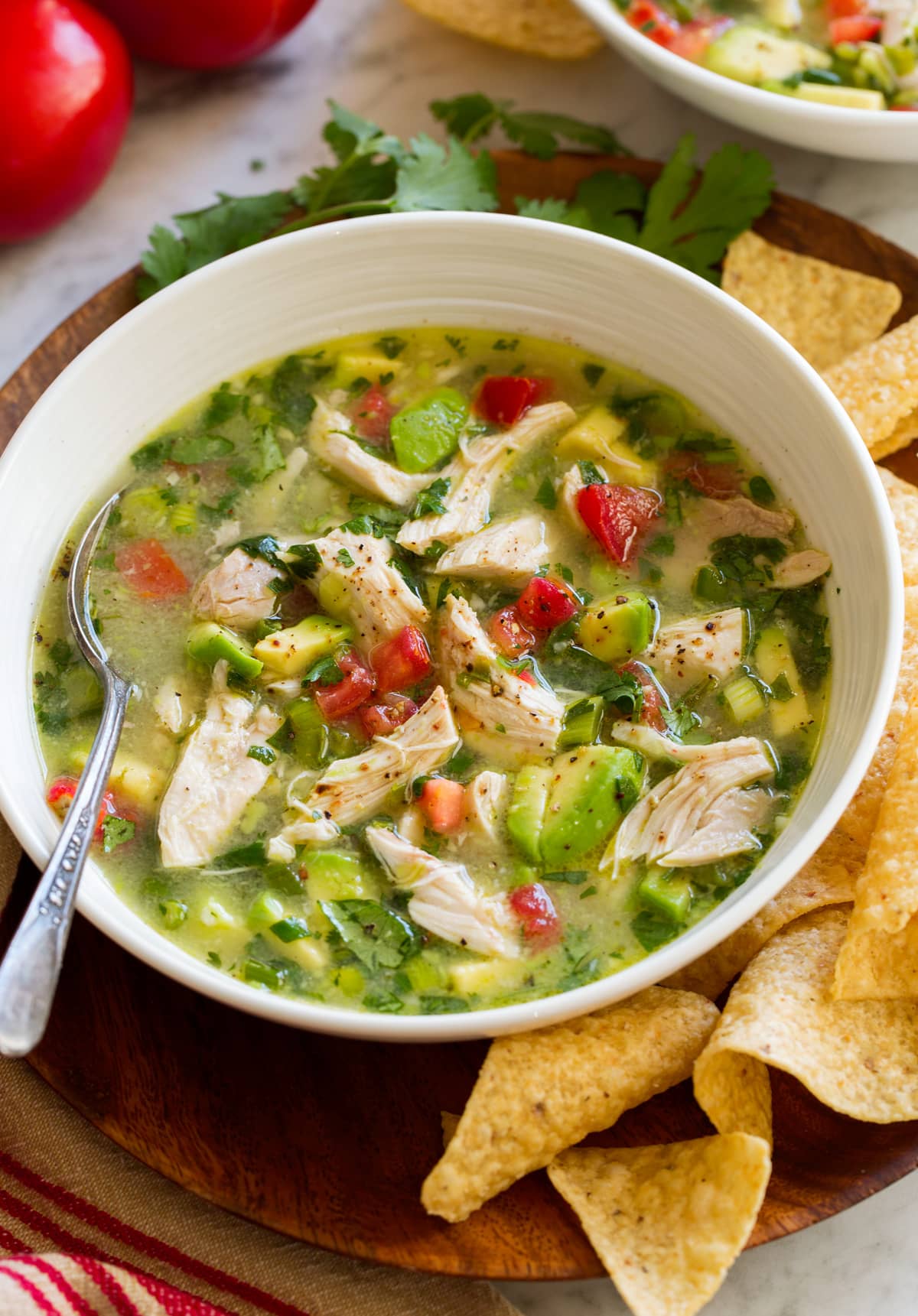 Chicken Avocado Soup Single serving of chicken avocado soup in a bowl shown from the side.