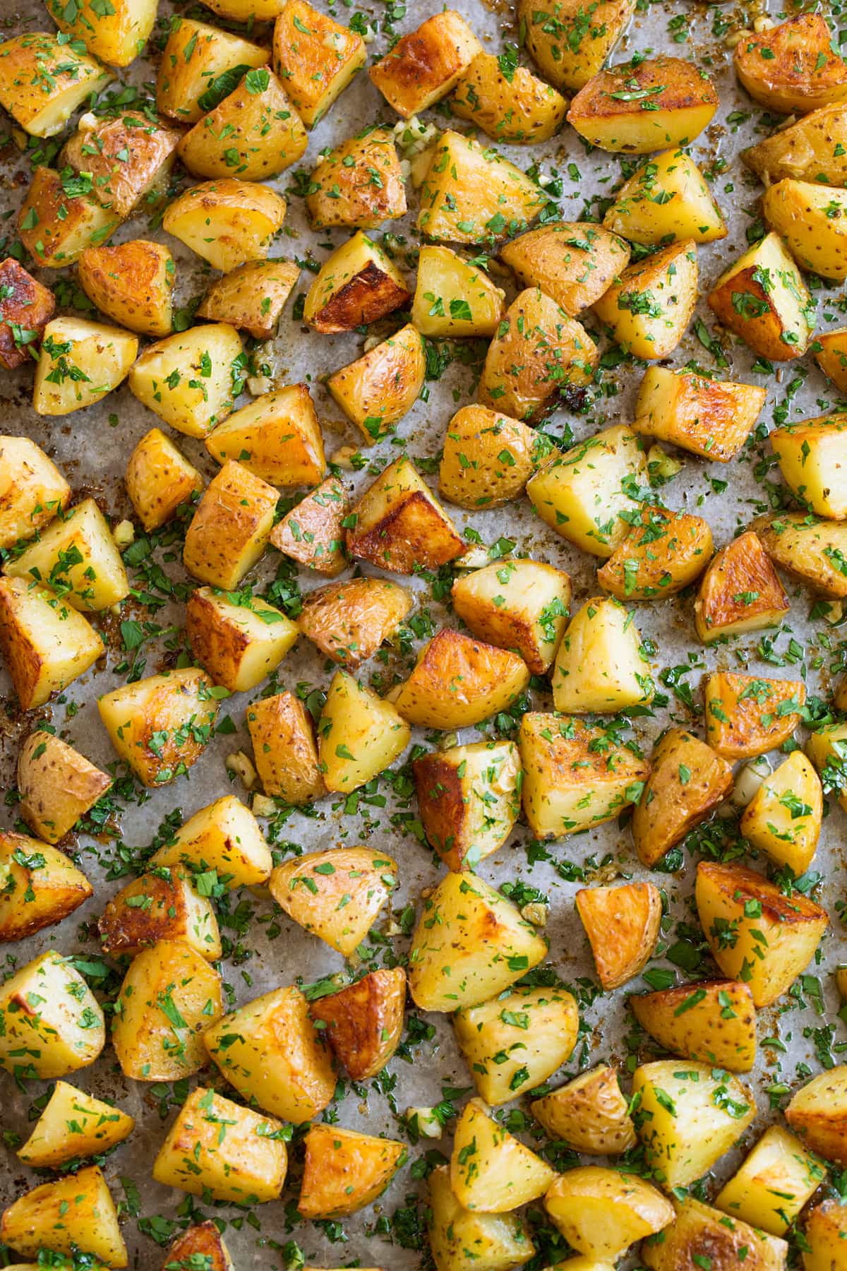 Lemon Roasted Potatoes Overhead image of lemon potatoes on a metal sheet pan.