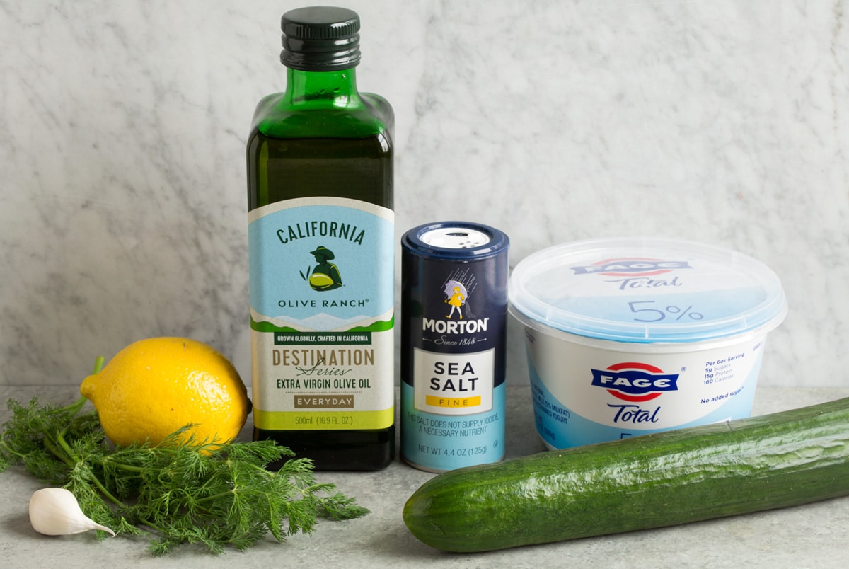 Homemade Tzatziki Sauce Image of ingredients used to make tzatziki sauces. Includes Greek yogurt, cucumber, salt, lemon, olive oil, dill and garlic.