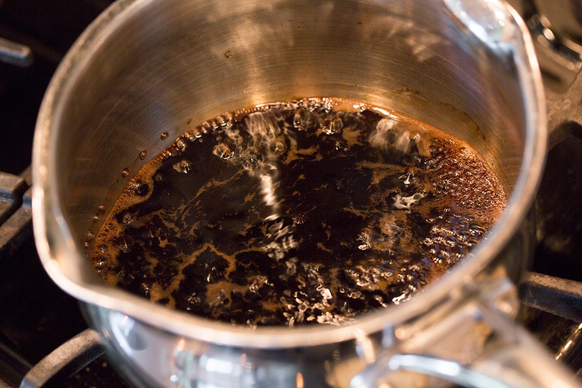 Caprese Salad Balsamic vinegar simmering in a small saucepan.