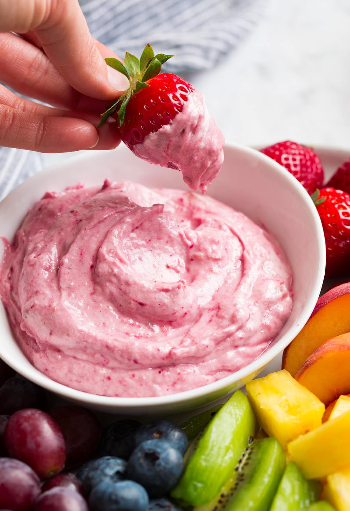 Easy Cream Cheese Fruit Dip Strawberry shown after dipping in cream cheese fruit dip.