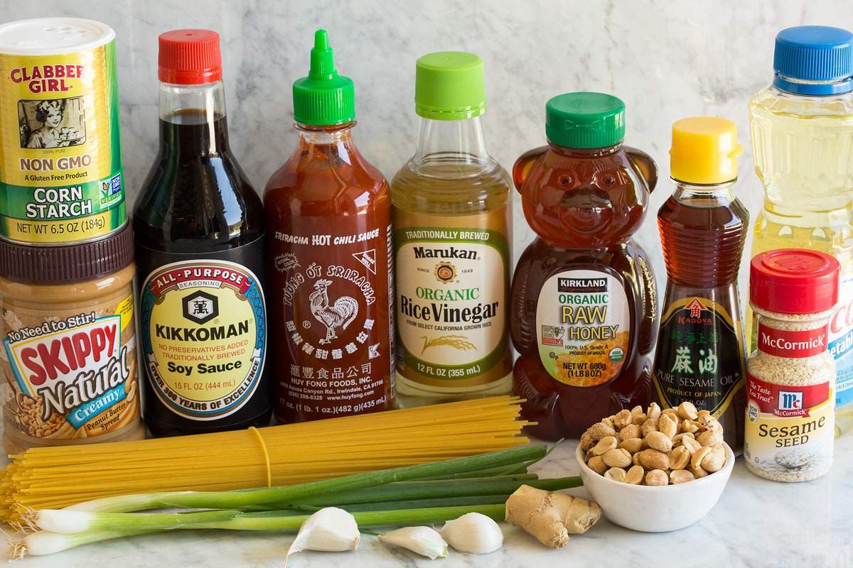 Sesame Noodles Photo: Ingredients used in making sesame noodles shown here. Includes spaghetti pasta, green onions, garlic, ginger, peanuts, sesame seeds, vegetable oil, sesame oil, honey, rice vinegar, sriracha, soy sauce, peanut butter and cornstarch.