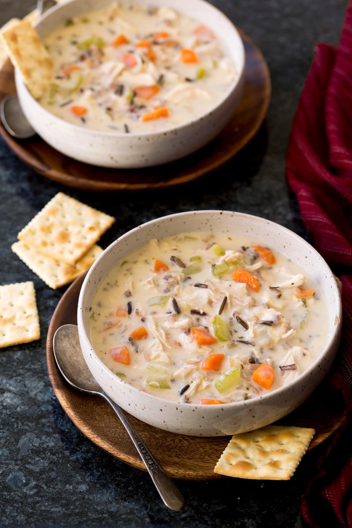 Creamy Chicken and Wild Rice Soup Two servings of chicken and wild rice soup in serving bowls.