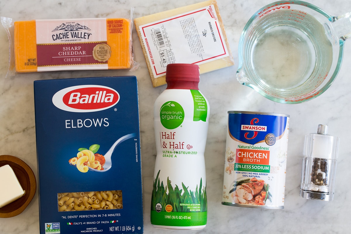 Instant Pot Mac and Cheese Image of ingredients used to make Instant Pot Mac and Cheese. Includes elbow pasta, cheddar, gruyere, half and half, chicken broth, water, butter, salt and pepper.