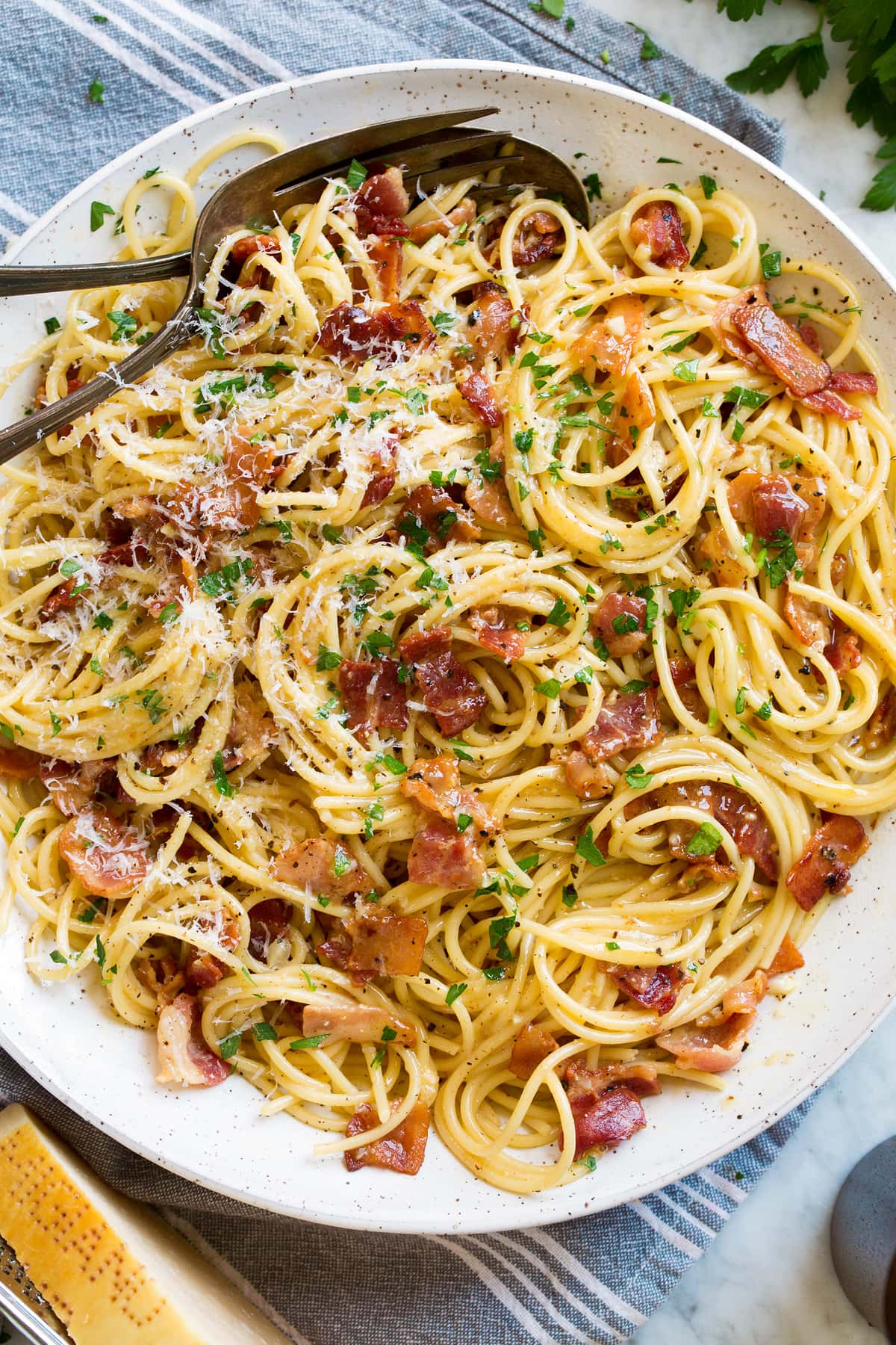 Pasta Carbonara Overhead image of spaghetti carbonara in a large serving bowl set over a grey kitchen cloth.