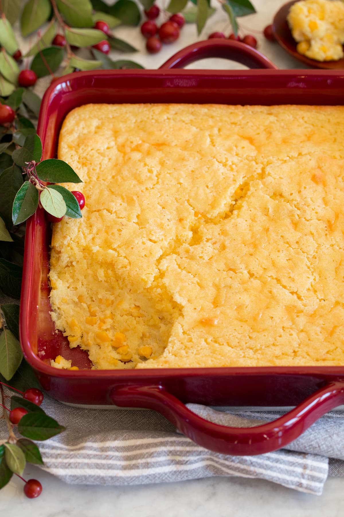 Corn Casserole Corn casserole shown from the side with a scoop removed.