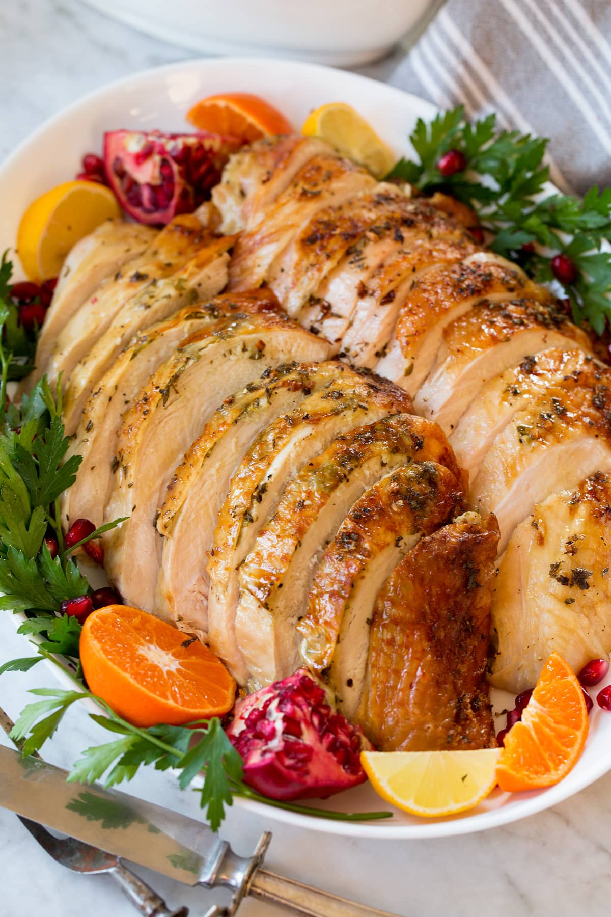 Roast Turkey Breast Roast Turkey Breast sliced on a serving platter with sides of fruit.