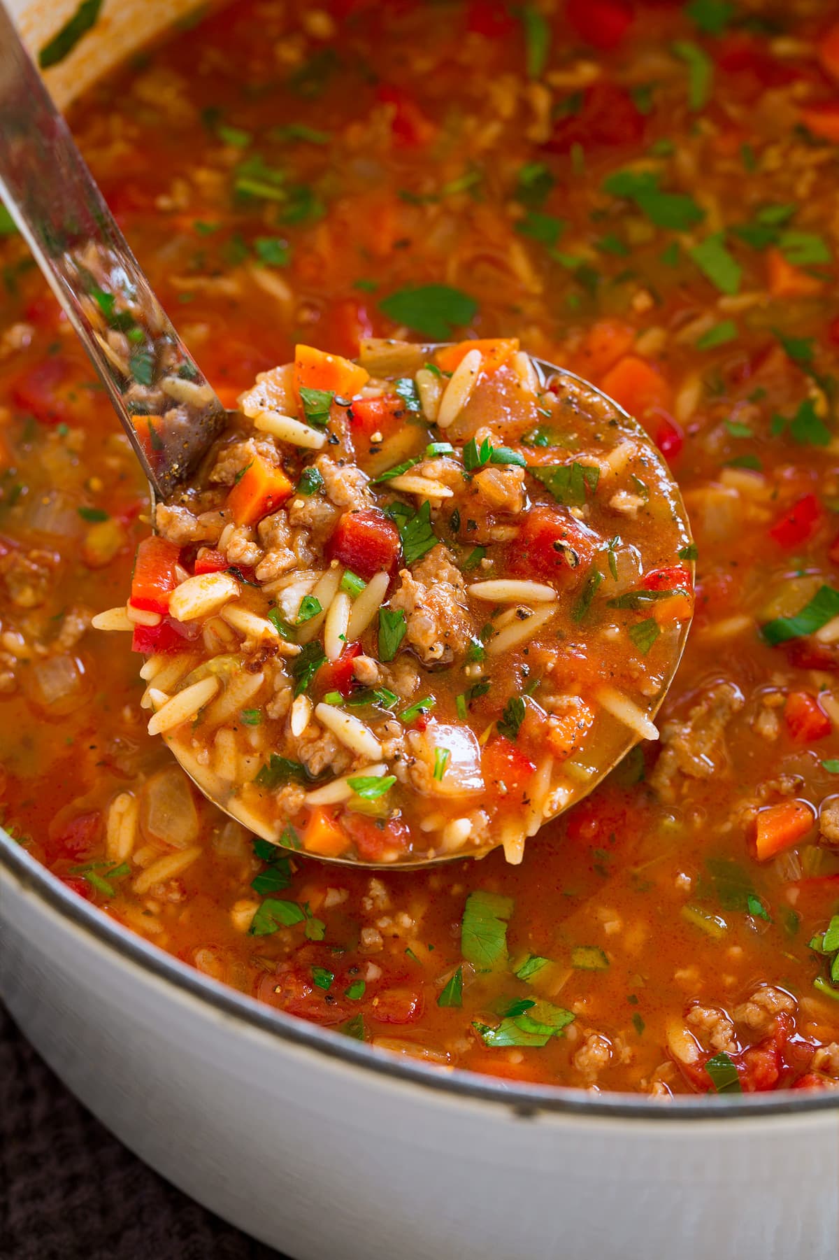 Italian Sausage Soup {with Orzo} Ladle full of sausage soup.