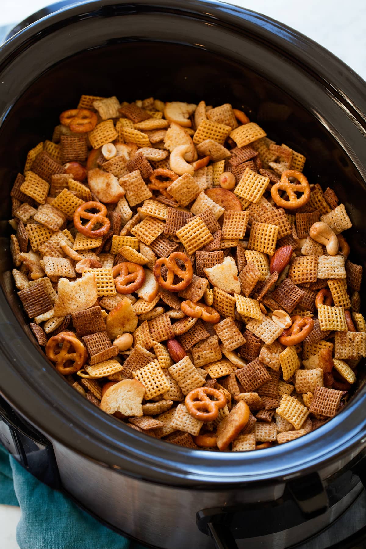 Chex Mix Chex Mix in a slow cooker shown after cooking.