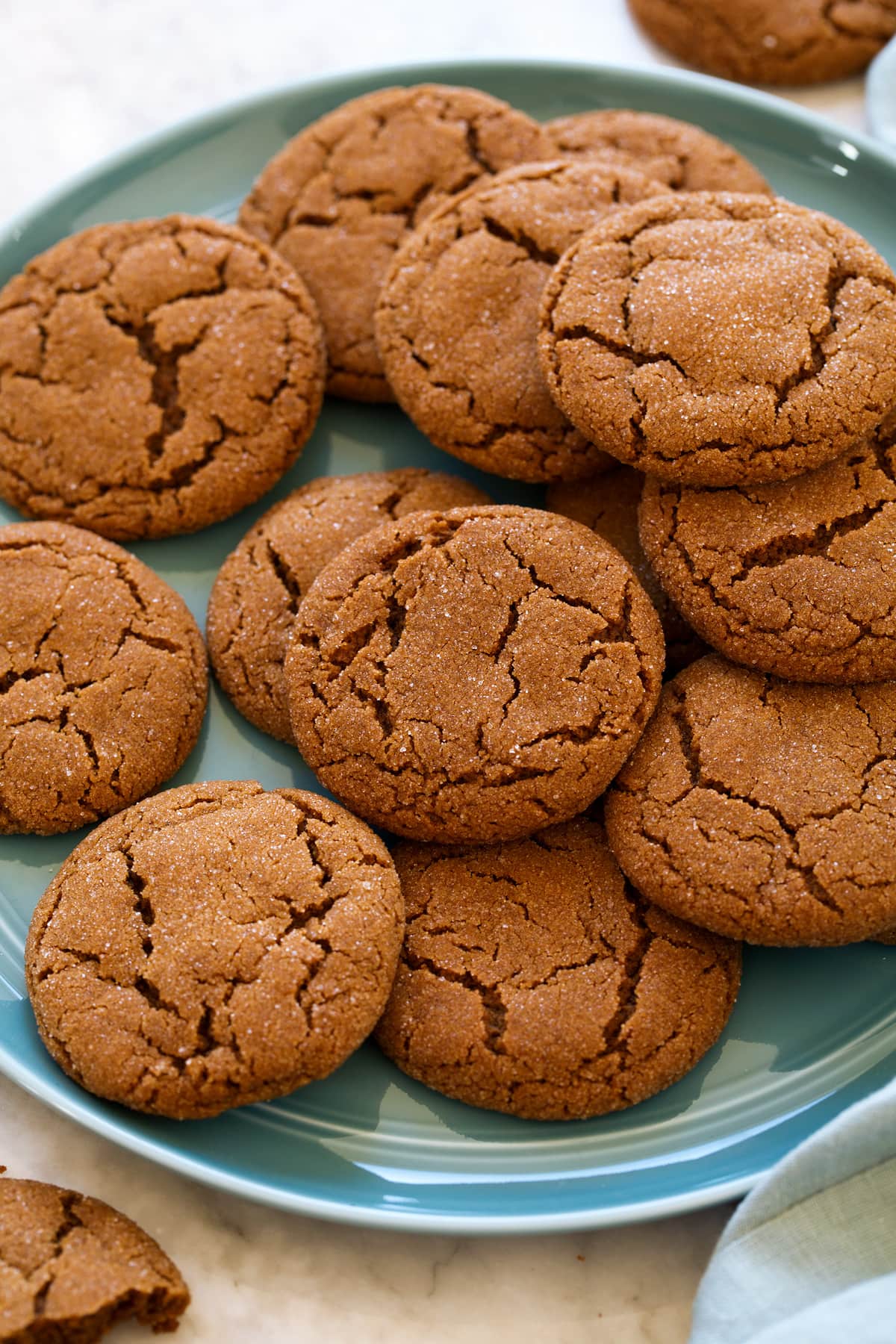Molasses Cookies Molasses cookies layered on a blue plate.