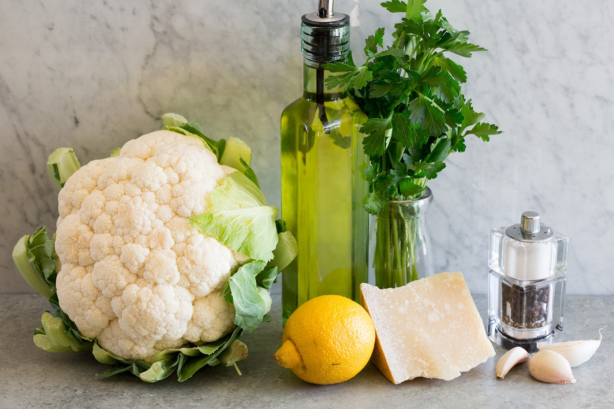 Cauliflower Rice Photo of ingredients used to make cauliflower rice. Includes fresh cauliflower, olive oil, parsley, garlic, parmesan, lemon, salt and pepper.