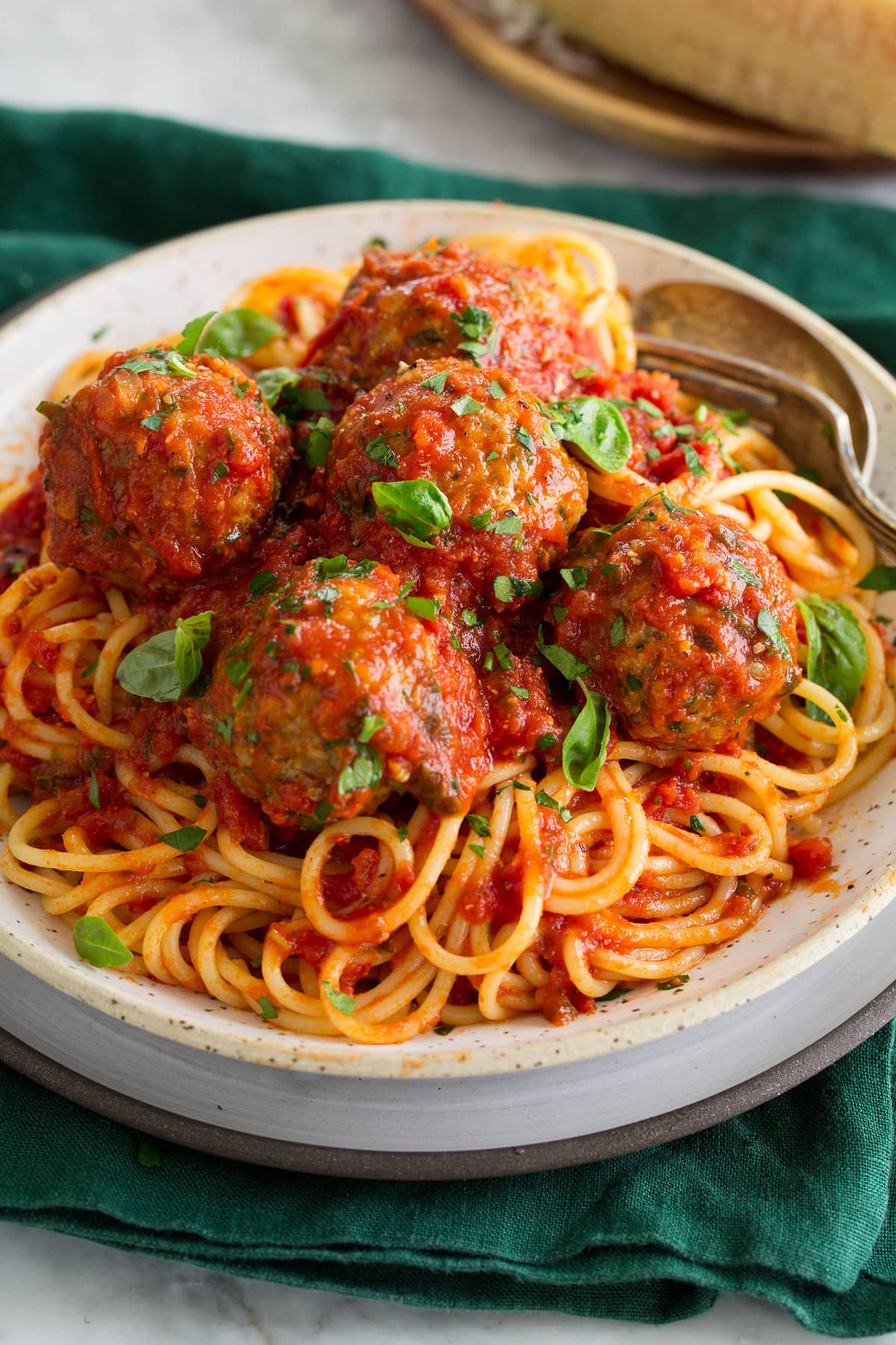 Turkey Meatballs Turkey meatballs and marinara sauce shown over spaghetti pasta.