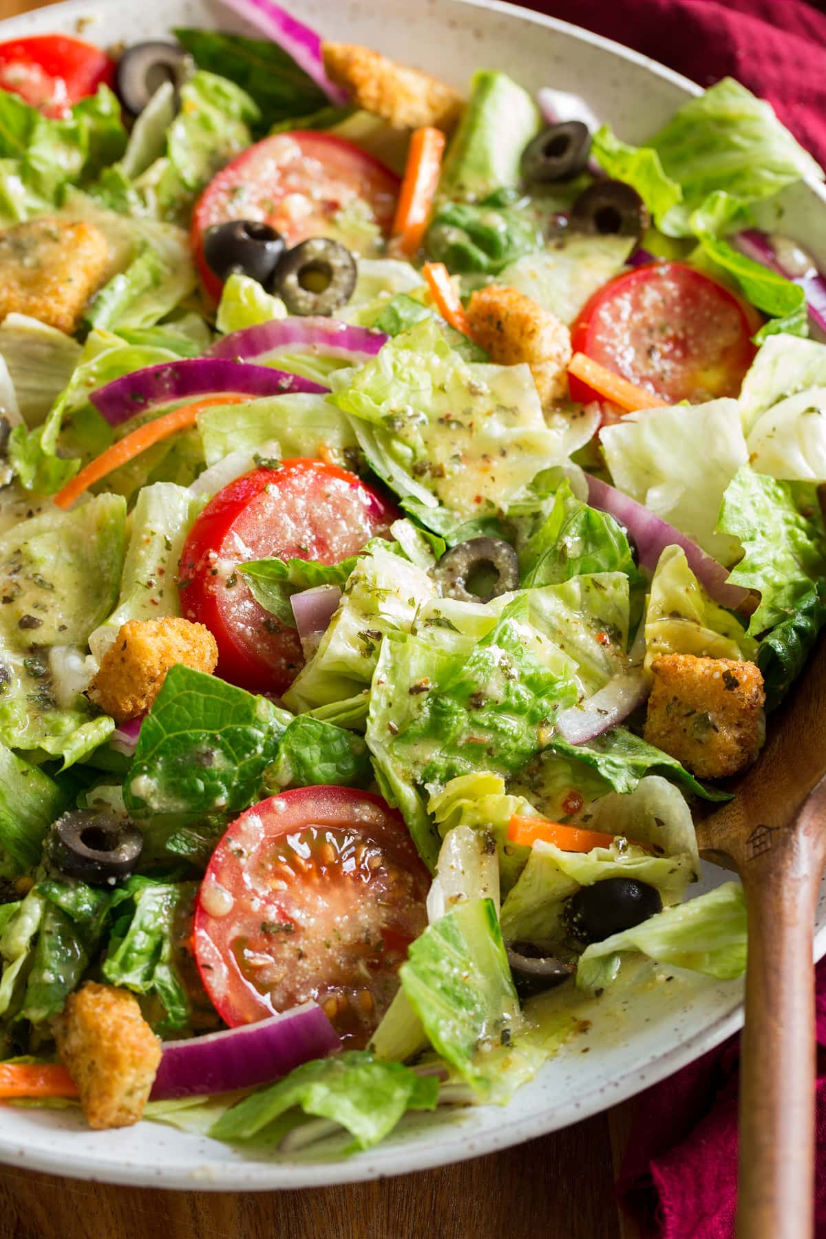 Italian Dressing Close up photo of salad tossed with homemade Italian salad dressing.