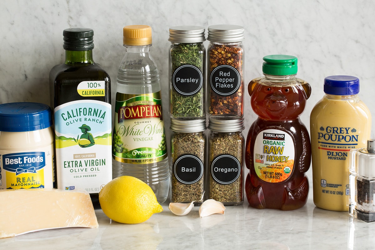 Italian Dressing Photo of ingredients used in making homemade Italian dressing. Includes mayonnaise, parmesan, olive oil, lemon, white wine vinegar, parsley, basil, oregano, red pepper flakes, garlic, honey, dijon mustard, salt and pepper.