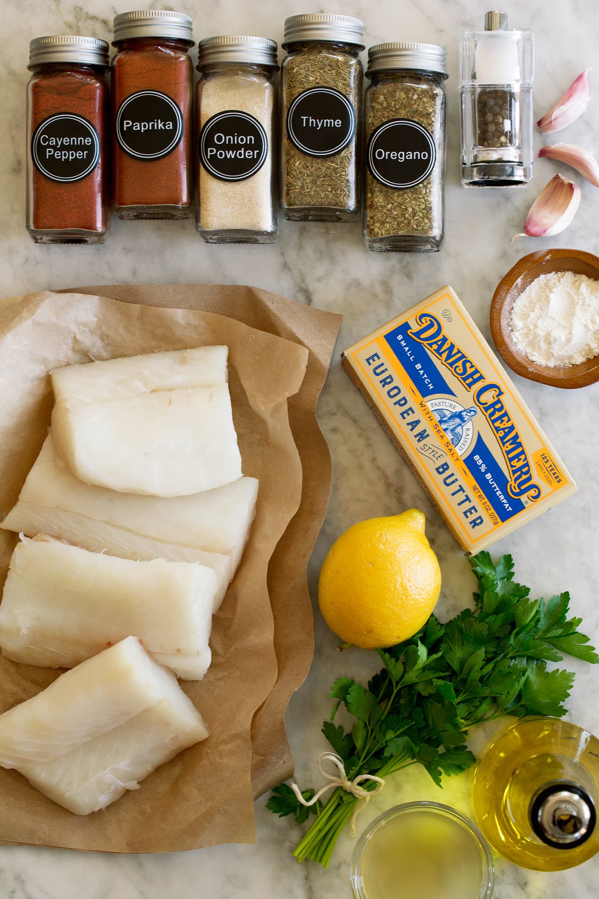 Lemon Butter Cod Photo of ingredients that are used to make this lemon butter cod recipe. Includes fresh cod fillets, oregano, thyme, onion powder, paprika, cayenne pepper, salt and pepper, flour, garlic, butter, lemon, parsley, olive oil, and chicken broth.