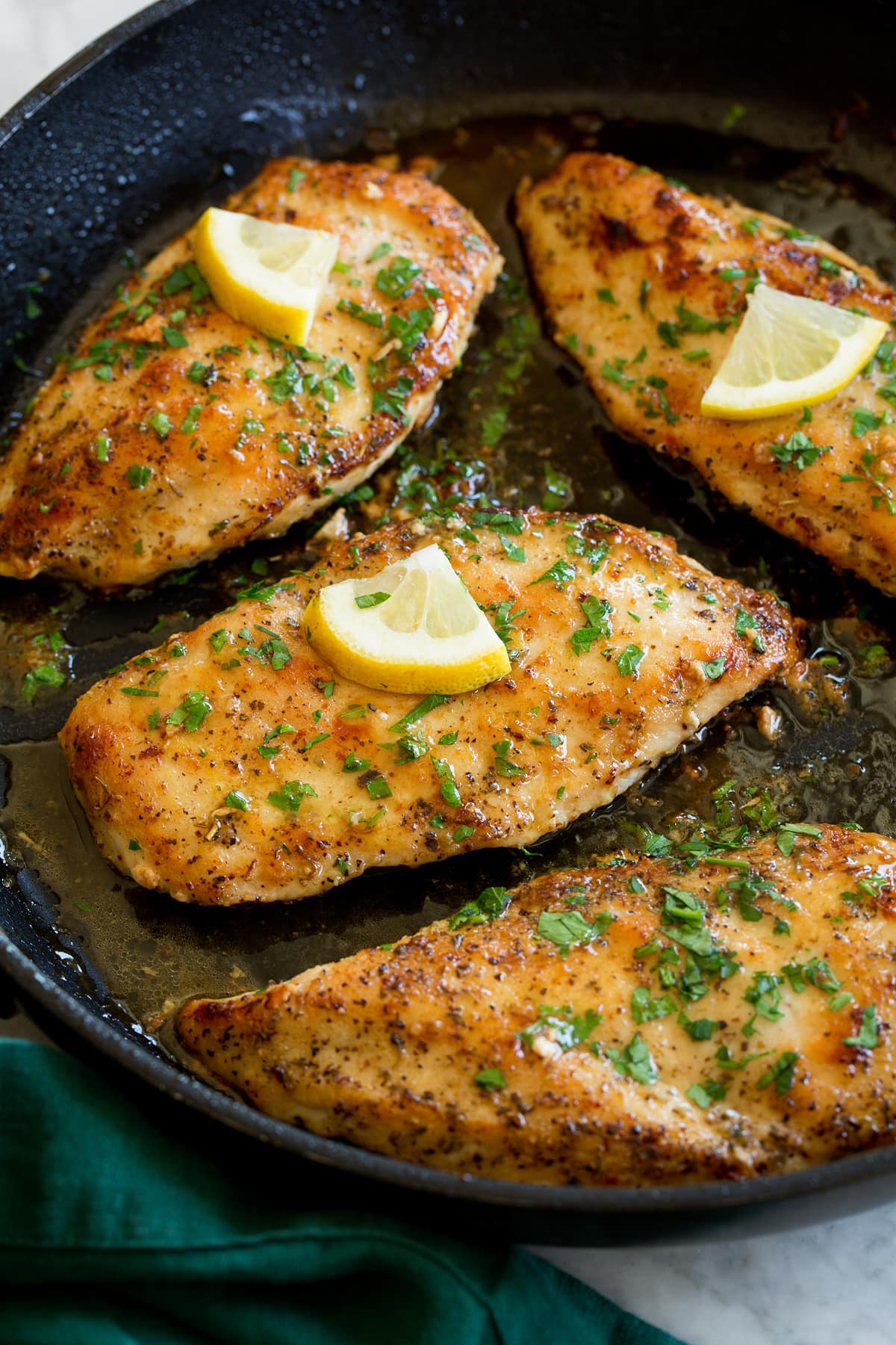 Lemon Pepper Chicken Lemon pepper chicken breasts in a black skillet.