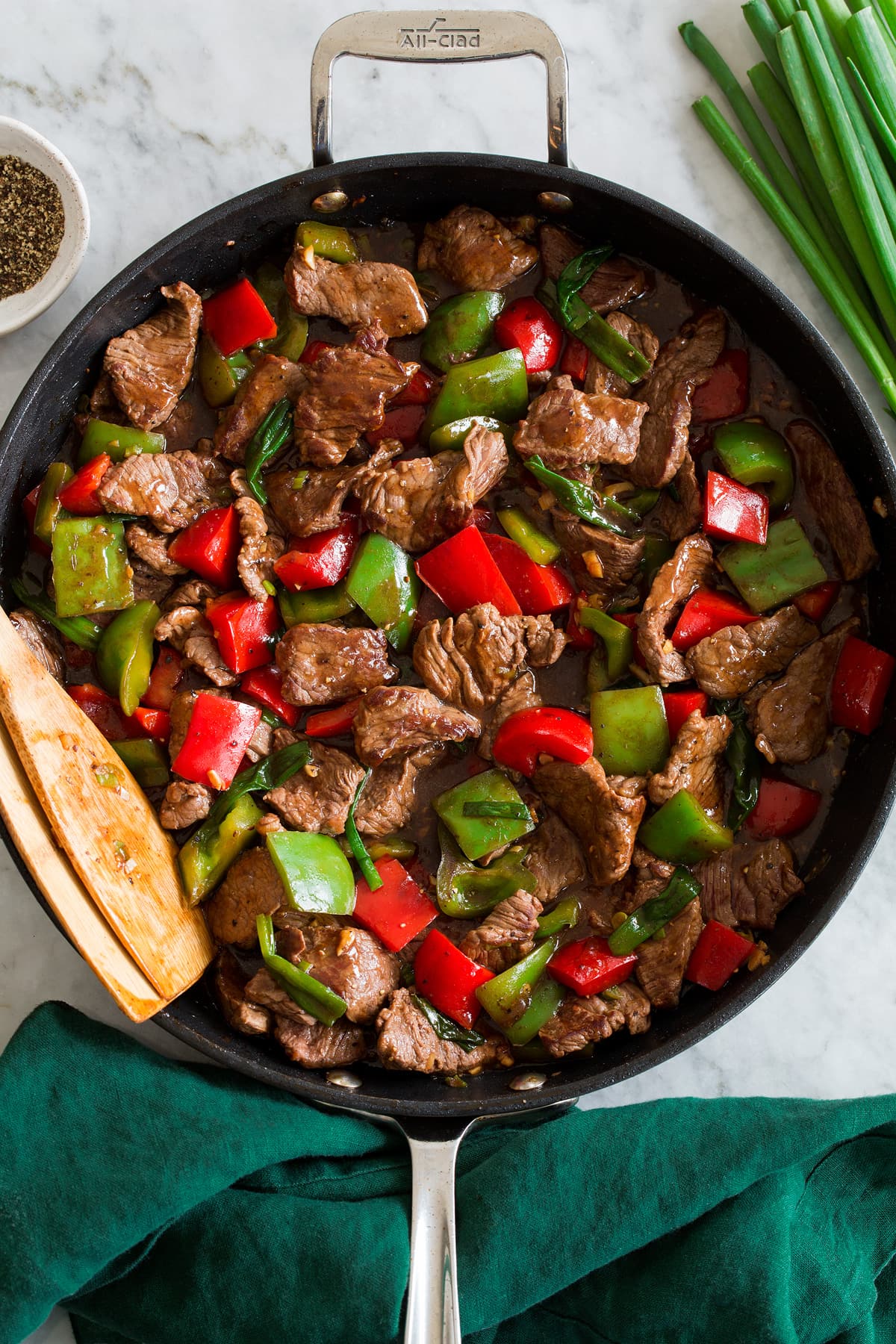 Pepper Steak Photo: Pepper steak and bell peppers shown in a dark skillet from above.