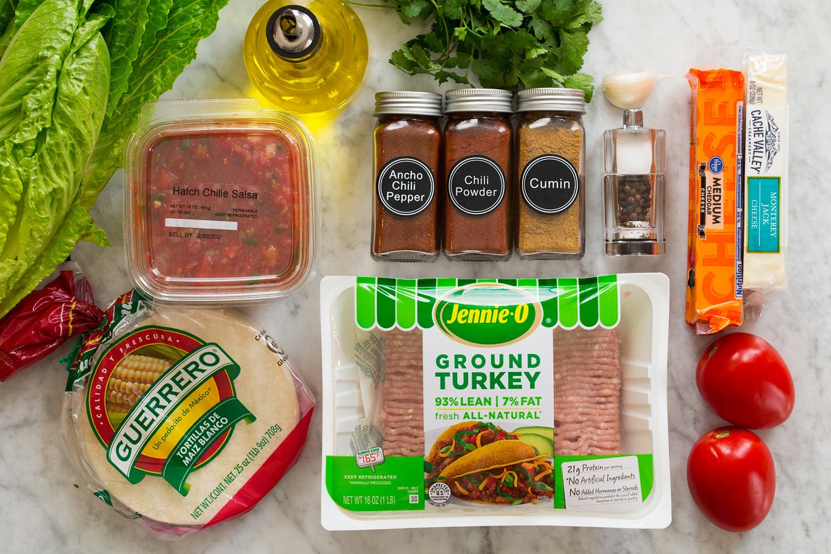 Ground Turkey Tacos Photo: Ingredients for turkey tacos. Includes ground turkey, corn tortillas, salsa, chili powders, cumin, salt, pepper, garlic, cilantro, tomatoes, cheese, lettuce and olive oil.