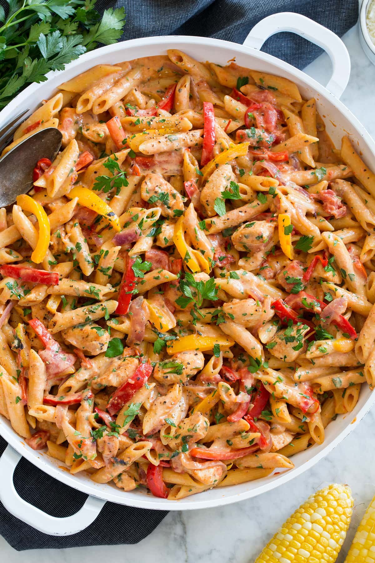 One Pan Creamy Cajun Chicken Pasta Photo: Creamy cajun chicken pasta shown in a large white pan from overhead.