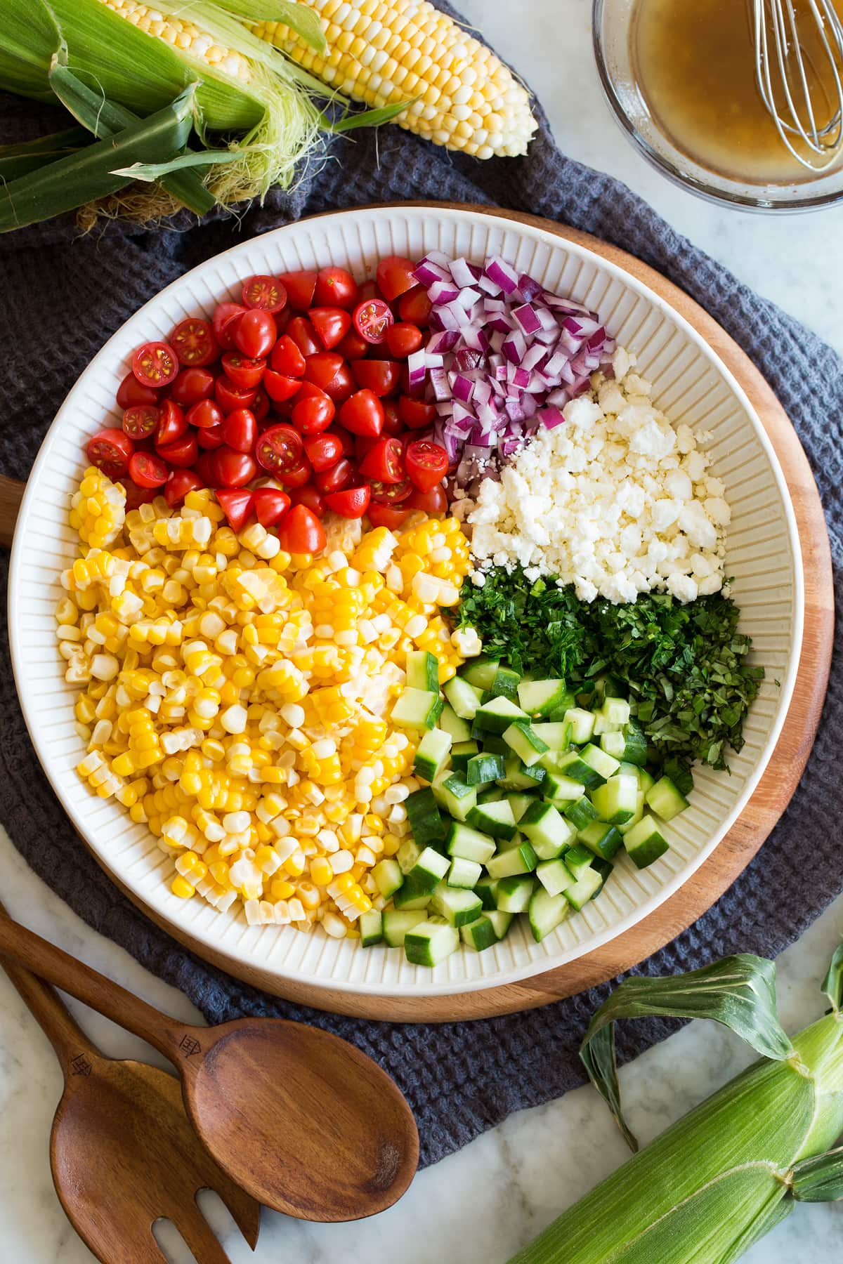 Corn Salad Photo: Corn salad ingredients shown divided into areas before tossing in a bowl. It is shown from above.