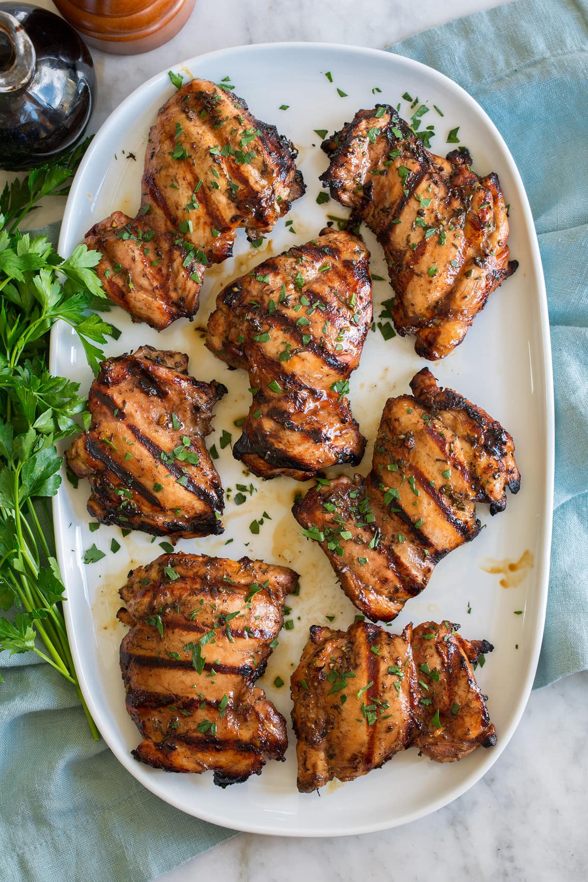 Balsamic Chicken Balsamic chicken thighs shown on an oval white platter from overhead.