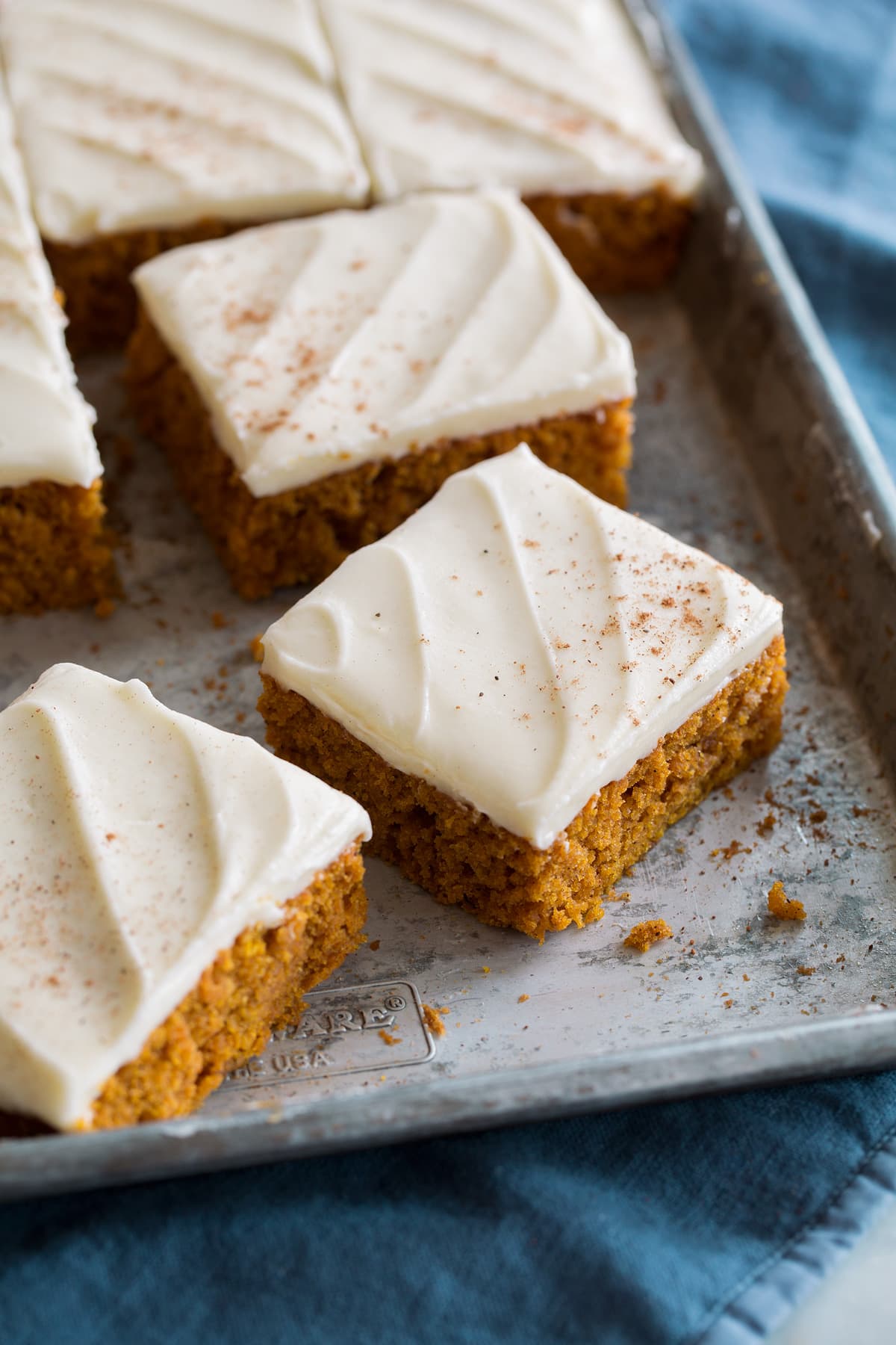 Pumpkin Bars Close up photo of sliced pumpkin bars on baking sheet.