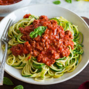 Zucchini Noodles shown topped with a beefy spaghetti sauce.