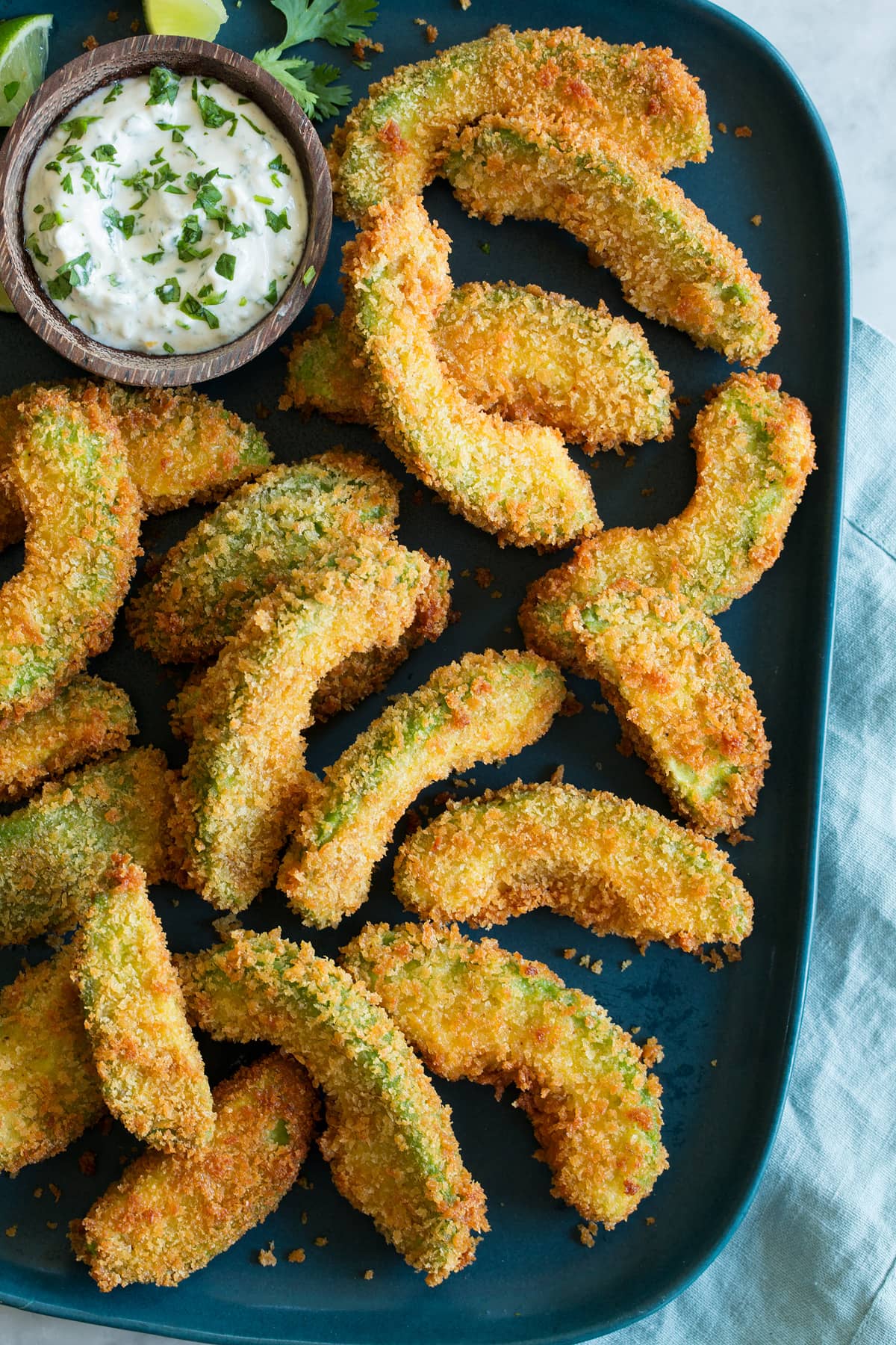 Avocado Fries Close up photo of breaded fried avocado slices, shown overhead.