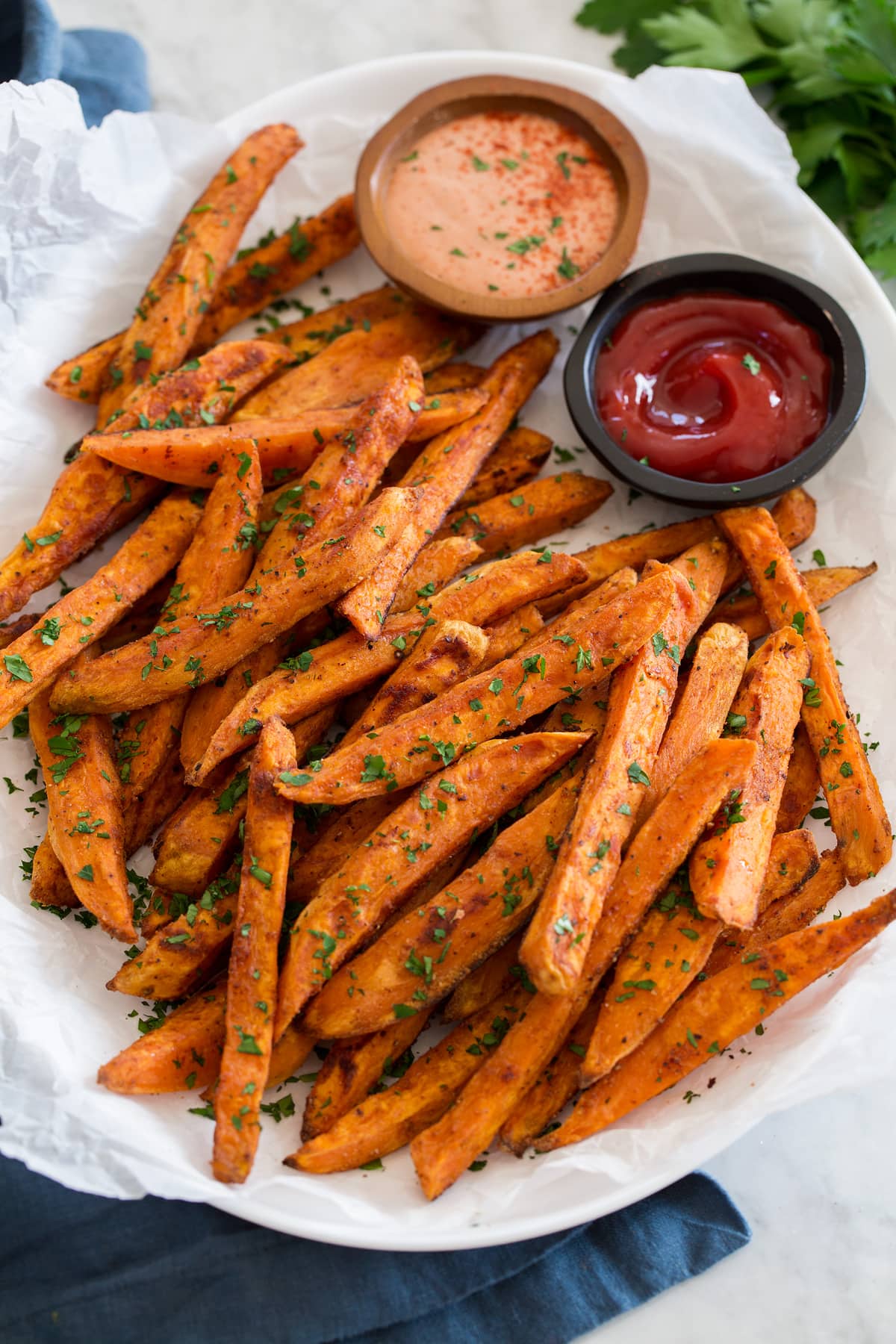 Baked Sweet Potato Fries Side angle of baked sweet potato fries on a serving tray.