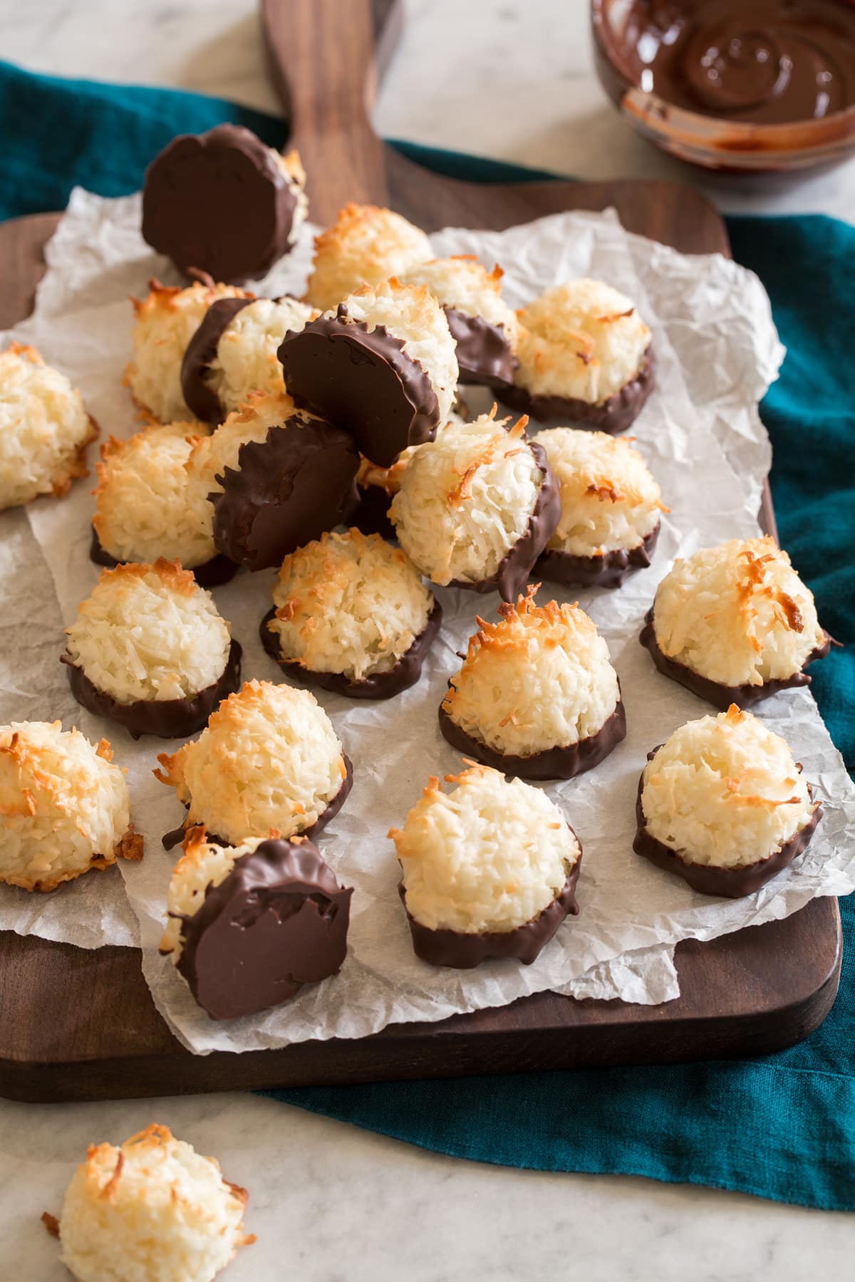 Coconut Macaroons Coconut macaroons on parchment paper and a wooden board.