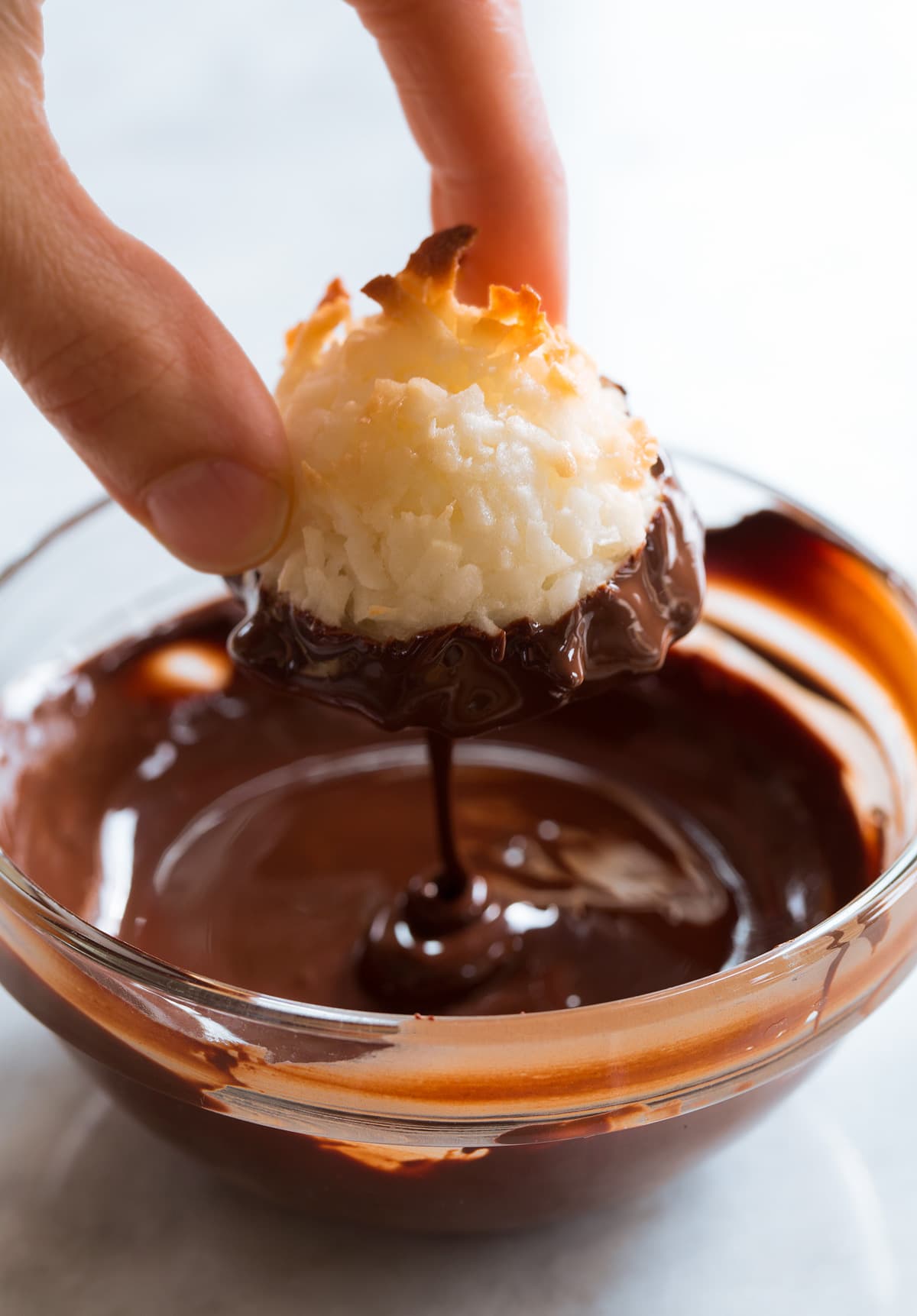 Coconut Macaroons Coconut Macaroon being dipped in chocolate.