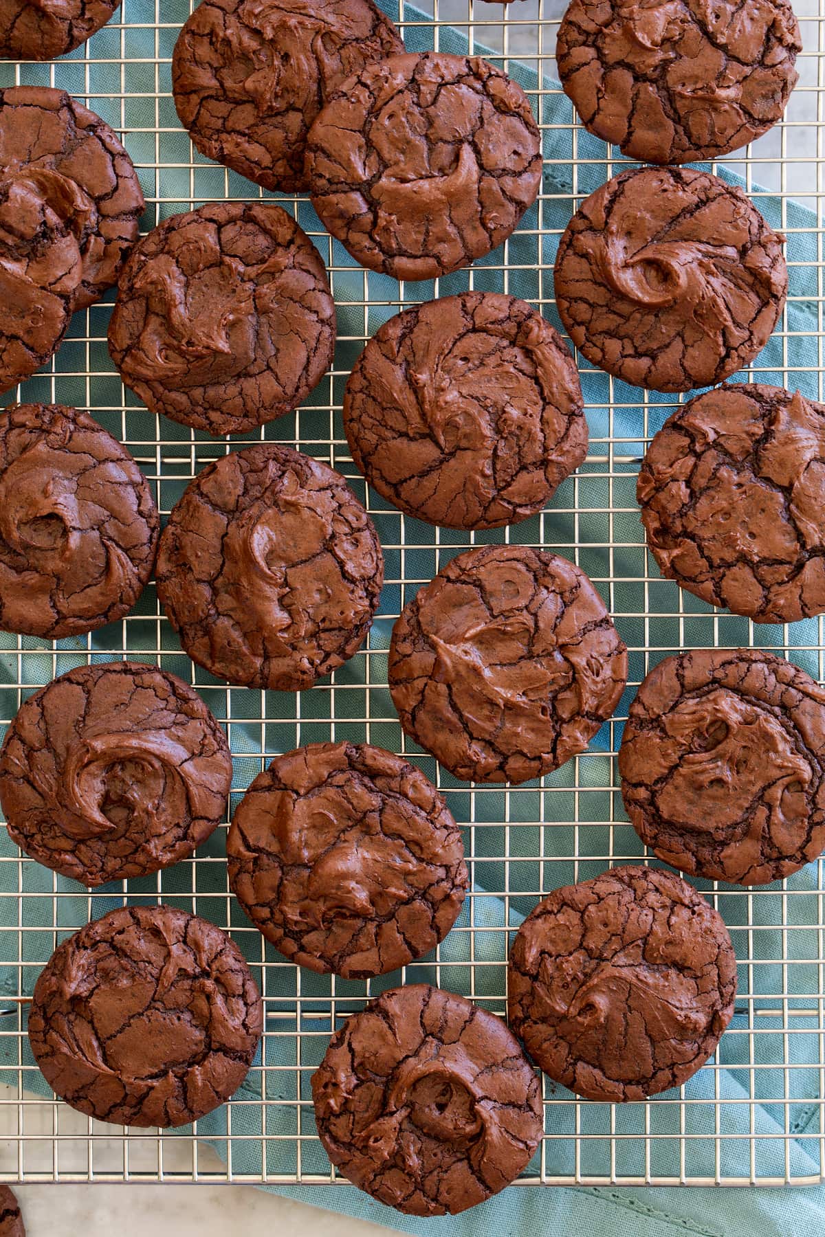 Brownie Cookies Overheat photo of chocolate brownie cookies on a silver wire cooling rack.