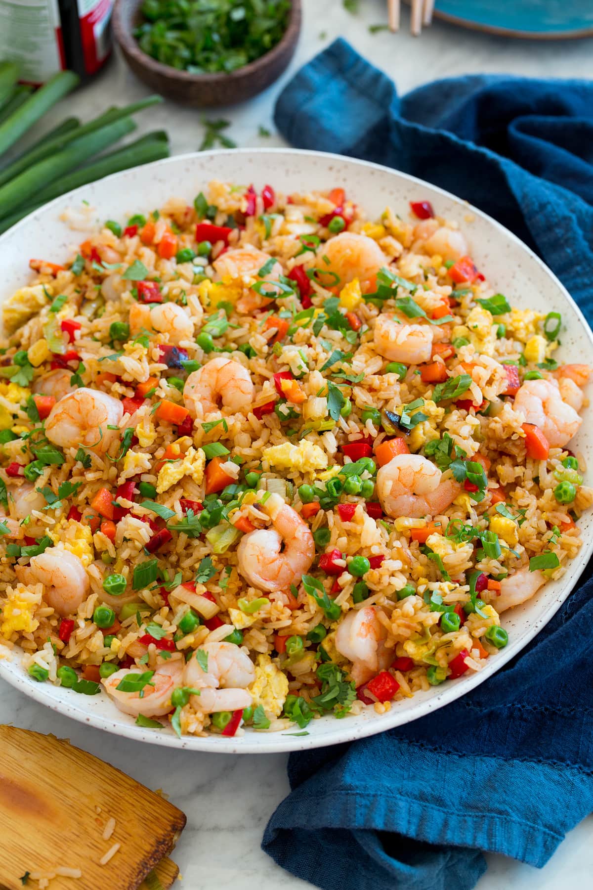 Shrimp Fried Rice Large white serving bowl with shrimp fried rice set on a marble surface.