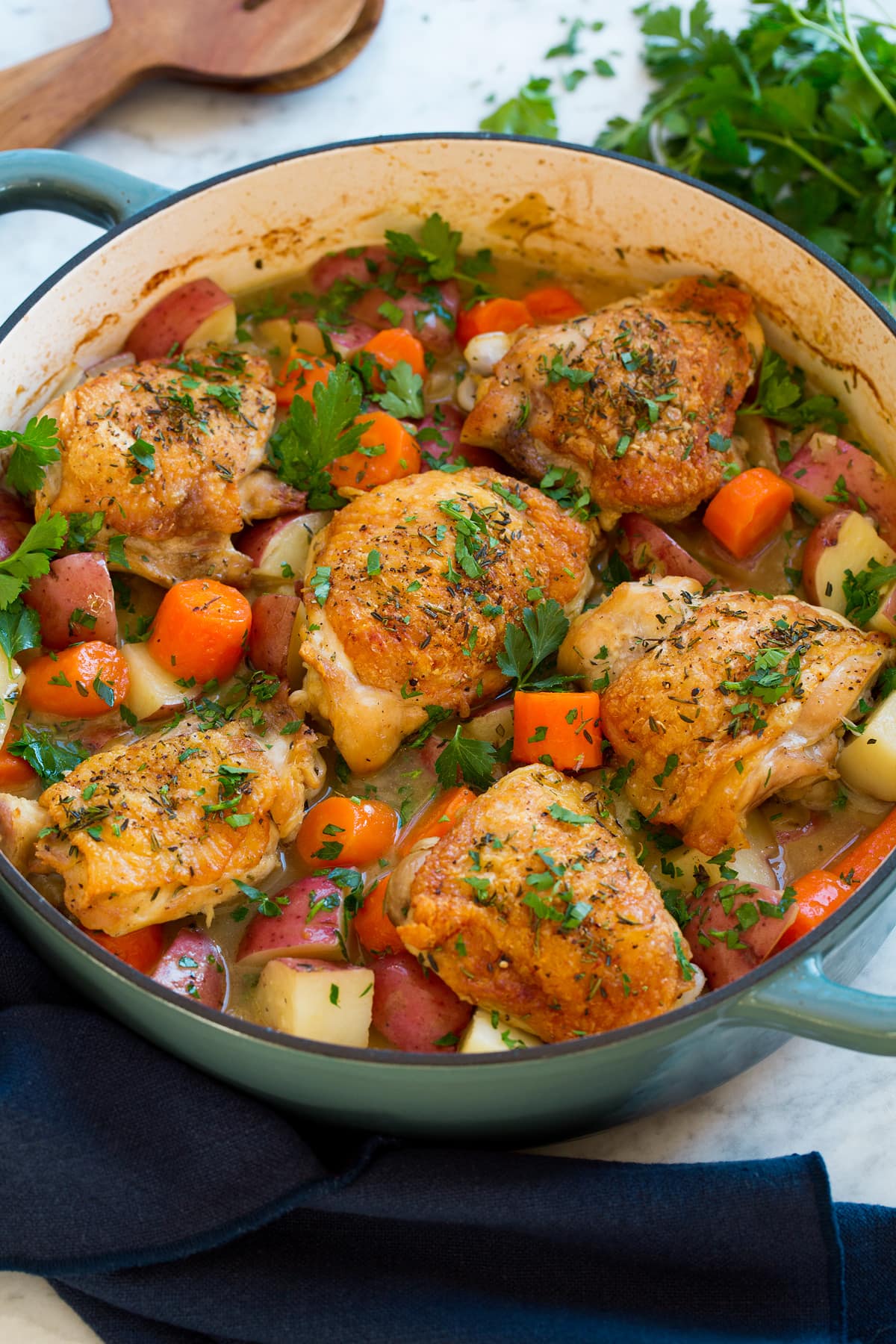 Braised Chicken and Vegetables Braised chicken thighs in a pot with vegetables.