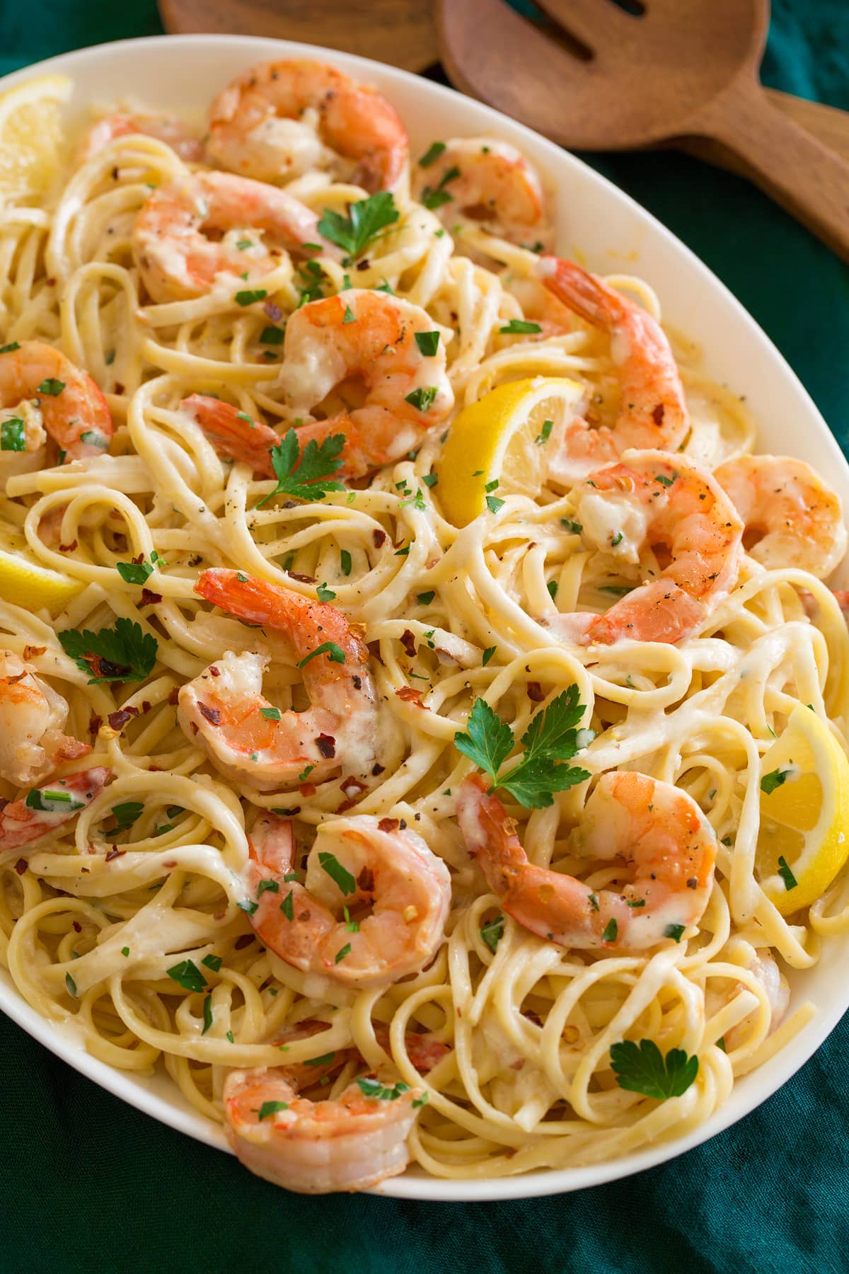 Creamy Lemon Shrimp Pasta Shrimp pasta with lemons shown on a platter from a side view.