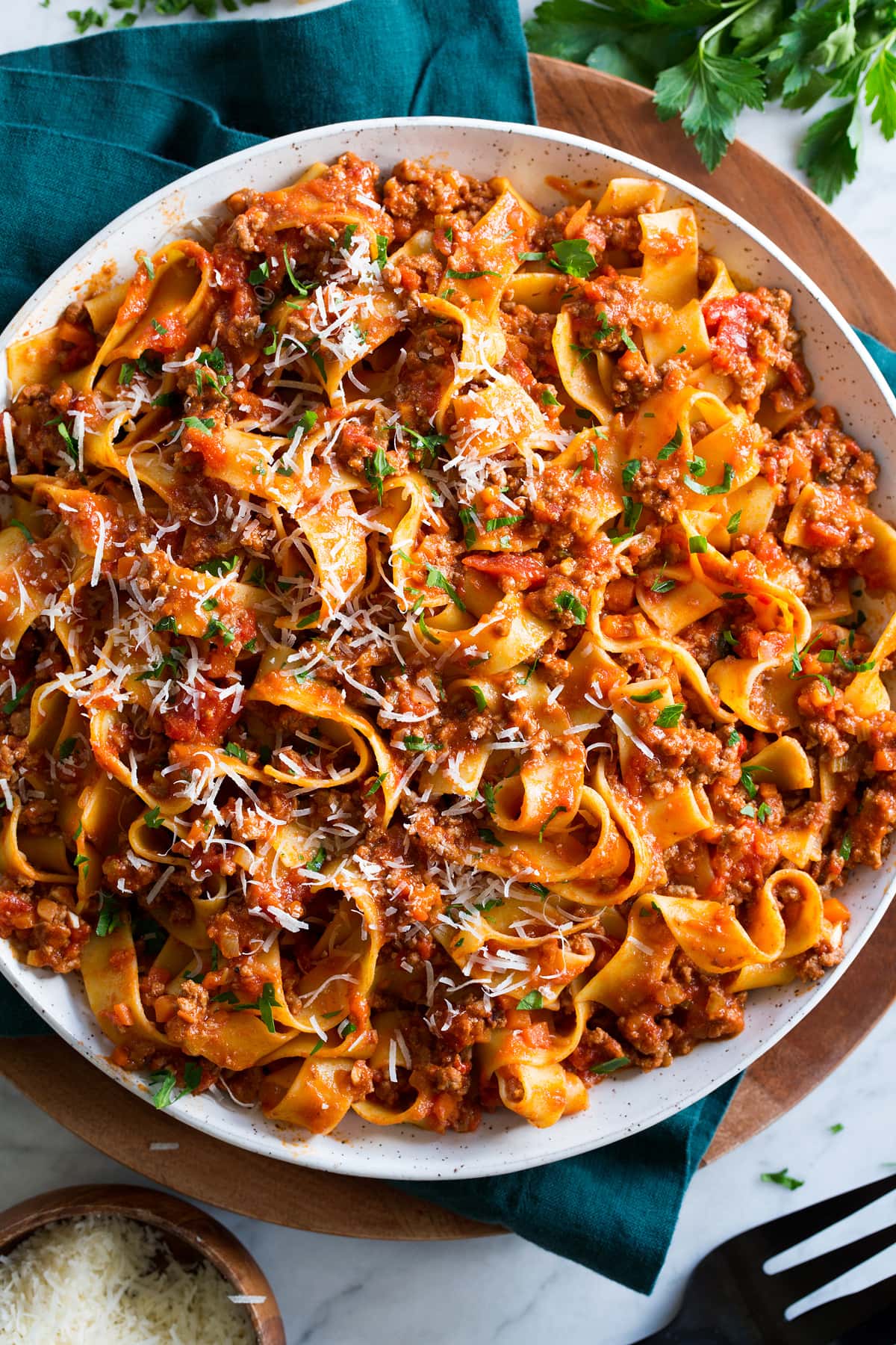 Bolognese Sauce Pappardelle with bolognese sauce, parmesan and parsley garnish.