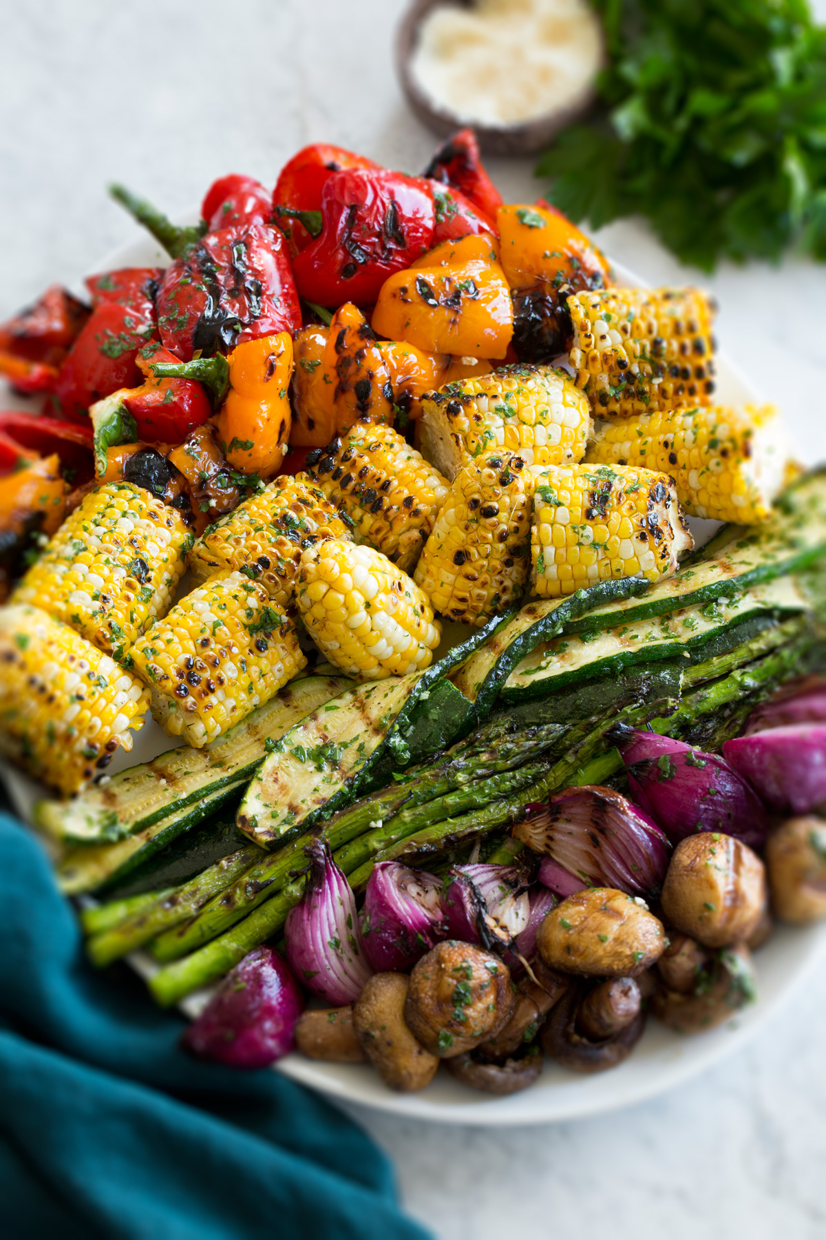 Grilled Vegetables Grilled vegetables shown on an oval platter from a side angle with a blue cloth to the side.