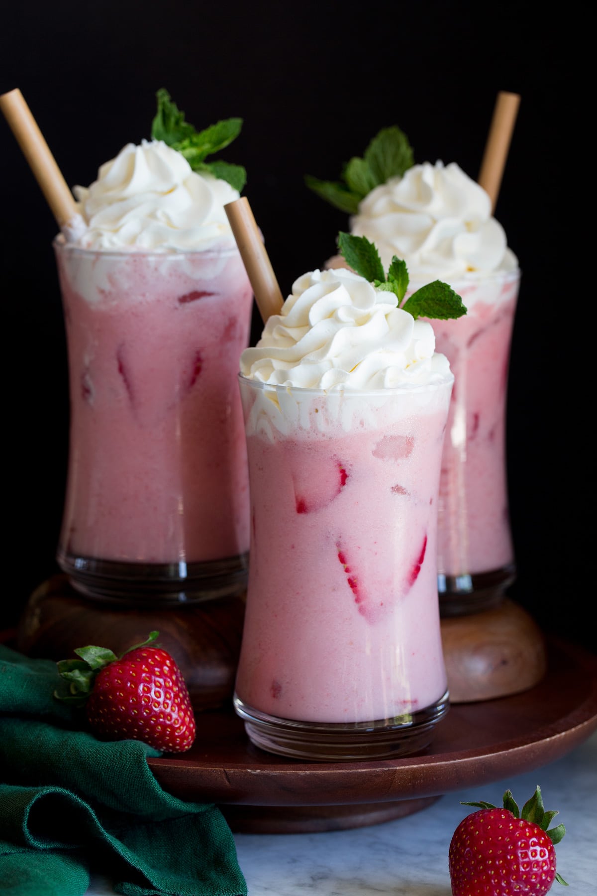 Pink Drink Recipe Copycat Starbucks Pink Drink recipe. Shows three servings topped with whipped cream.