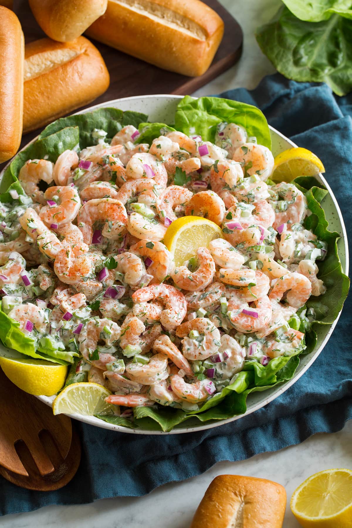 Shrimp Salad Shrimp salad with lemons and lettuce in a serving bowl.