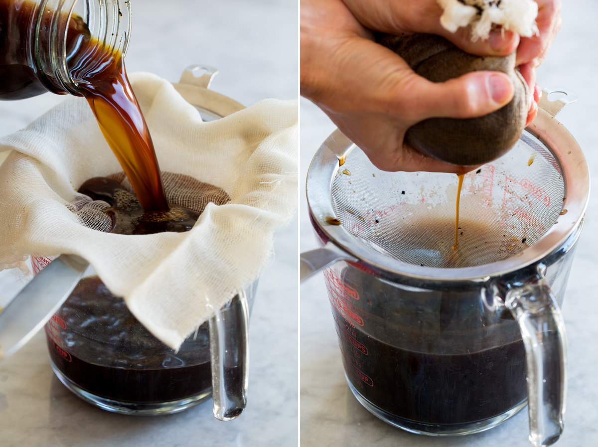 Iced Coffee Ground coffee being strained through a cheesecloth over a sieve on a glass measuring cup.