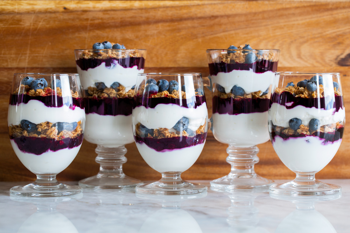 Yogurt Parfaits Five glasses filled with yogurt parfaits.