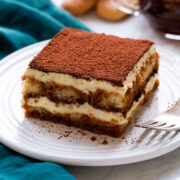 Slice of homemade tiramisu on a dessert plate.