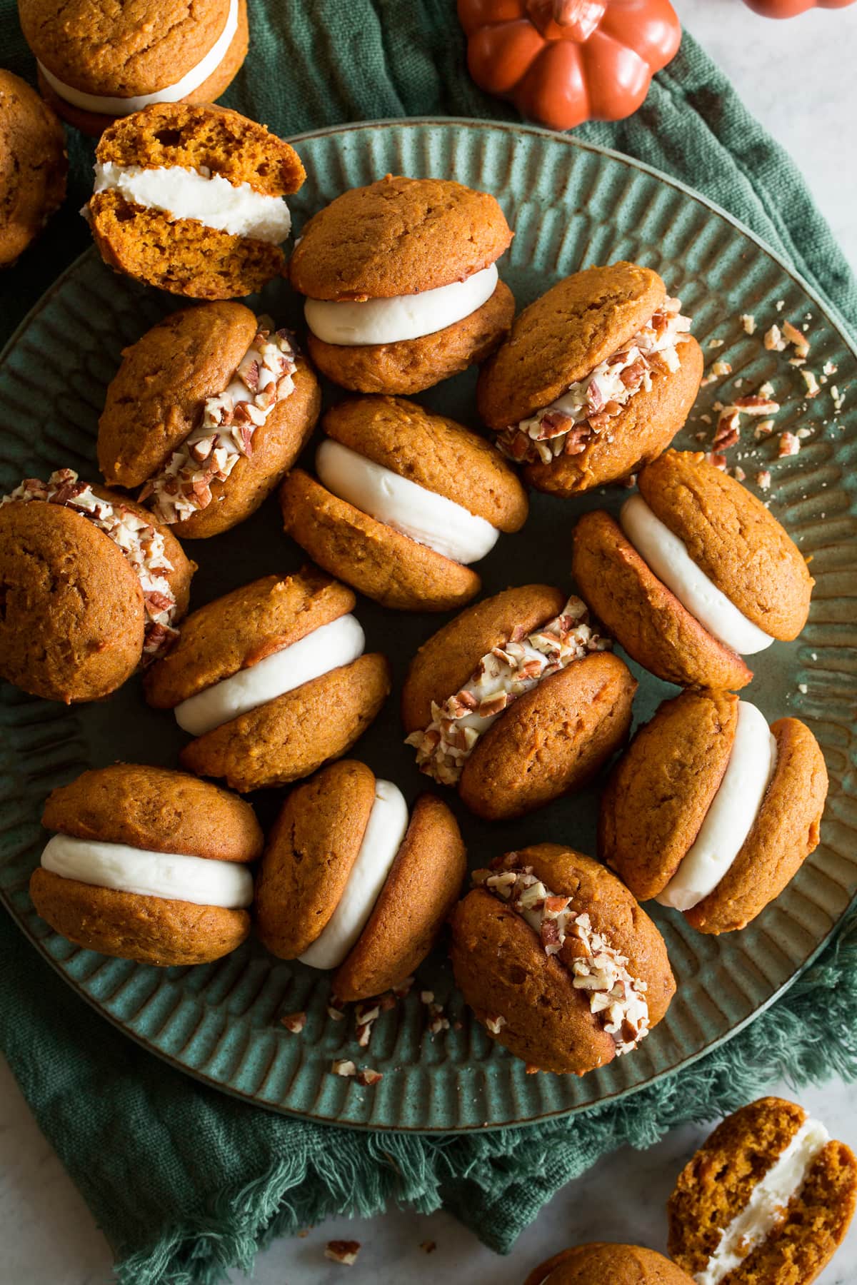 Pumpkin Whoopie Pies Pumpkin whoopie pies shown overhead on a large turquoise plate.