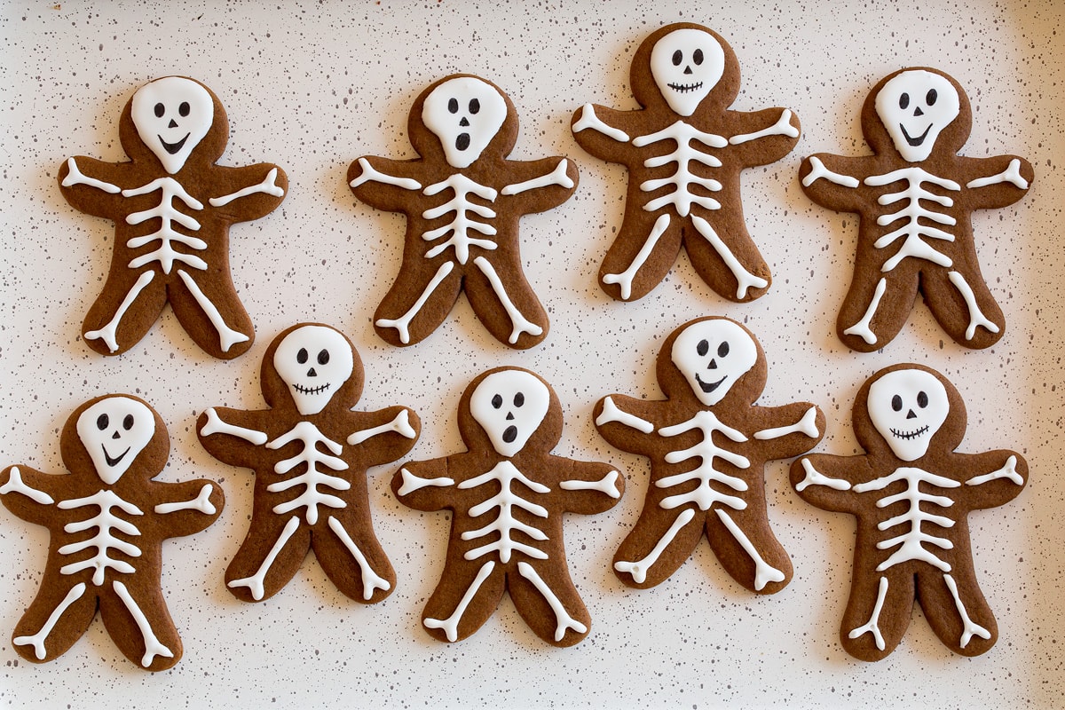 Skeleton Gingerbread Cookies Two rows of finished skeleton gingerbread cookies